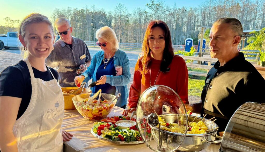 Guests enjoy a beautifully catered buffet with fresh salads and pasta during an outdoor celebration—perfect for birthday gatherings, private parties, and unforgettable events.