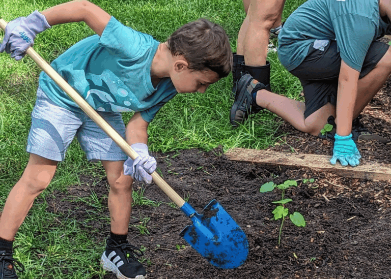 Children participating in planting lessons at Hobe Sound Farms summer program