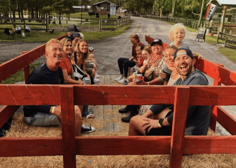 Families enjoying a tractor hayride at Hobe Sound Farms during Farm Explorer Wednesdays