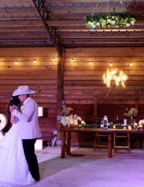 Bride and groom sharing their first dance inside Magnolia Barn at Hobe Sound Farms wedding venue in South Florida